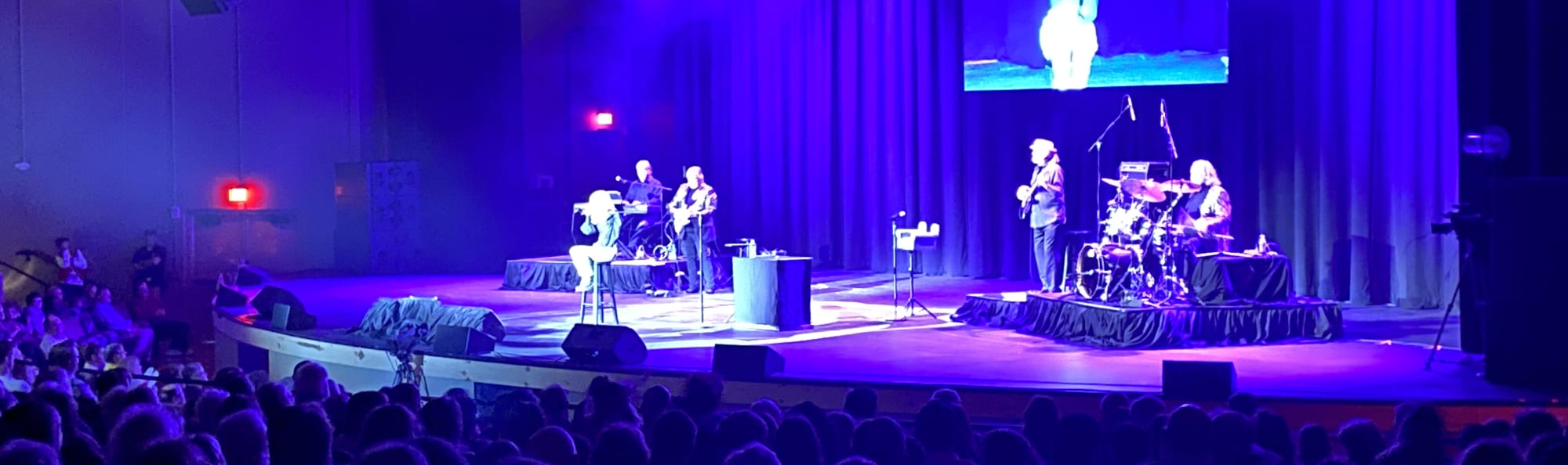 signer on stage in chair washed out by the lights Harrisburg